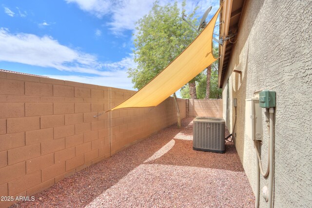 view of yard with cooling unit and a fenced backyard