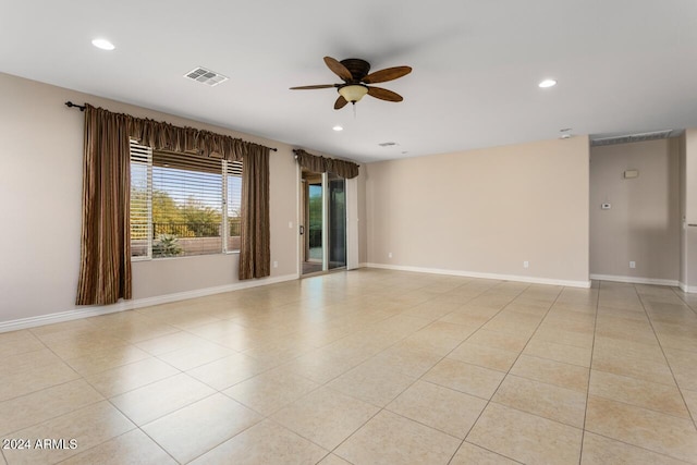 spare room featuring ceiling fan and light tile patterned floors