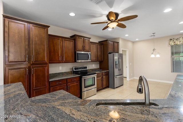 kitchen featuring ceiling fan, sink, hanging light fixtures, light tile patterned flooring, and appliances with stainless steel finishes