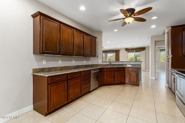 kitchen with sink, ceiling fan, light tile patterned flooring, kitchen peninsula, and stainless steel appliances