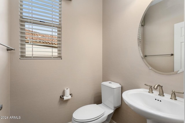 bathroom featuring toilet and sink