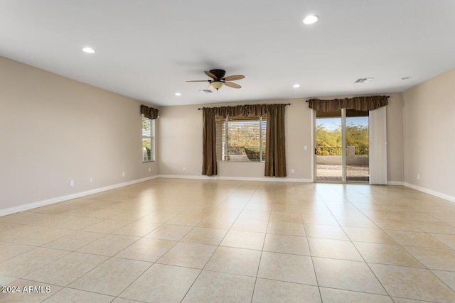 empty room featuring ceiling fan and light tile patterned floors