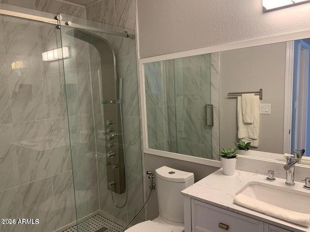 bathroom with vanity, toilet, and walk in shower