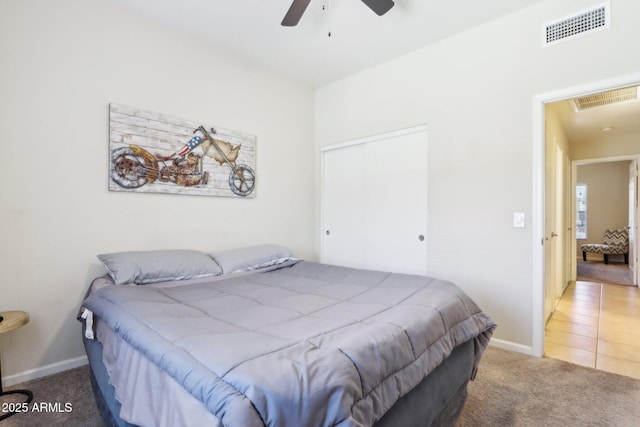 bedroom featuring carpet, baseboards, ceiling fan, and a closet