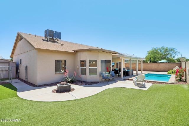 back of house with a patio, an outdoor fire pit, central AC, a gate, and stucco siding