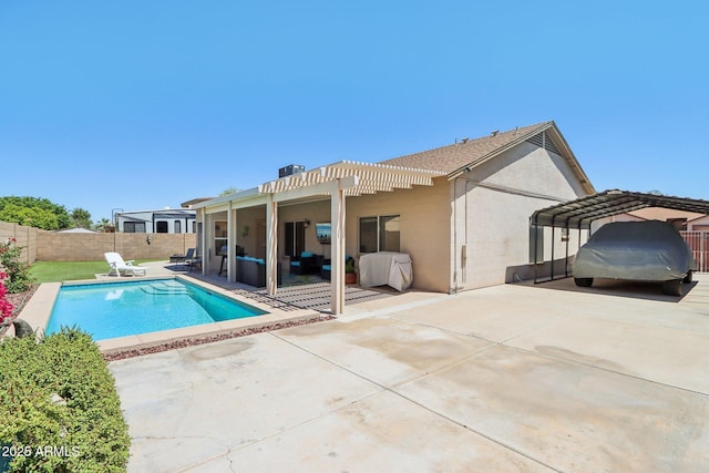 rear view of property with a detached carport, concrete block siding, a pergola, a fenced backyard, and a patio
