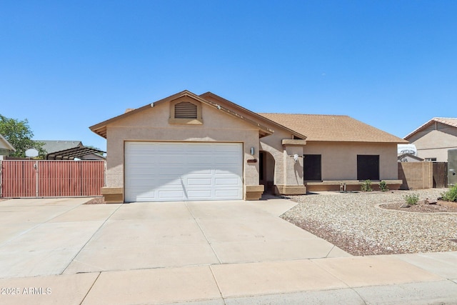 single story home with concrete driveway, stucco siding, a gate, and a garage