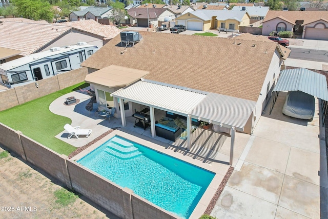view of pool with a residential view, a fenced backyard, a patio area, and cooling unit