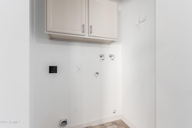 clothes washing area featuring cabinets, gas dryer hookup, hookup for a washing machine, and hookup for an electric dryer