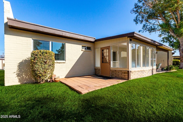 back of property featuring a patio and a lawn