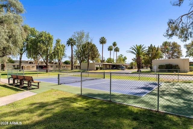 view of sport court featuring a lawn