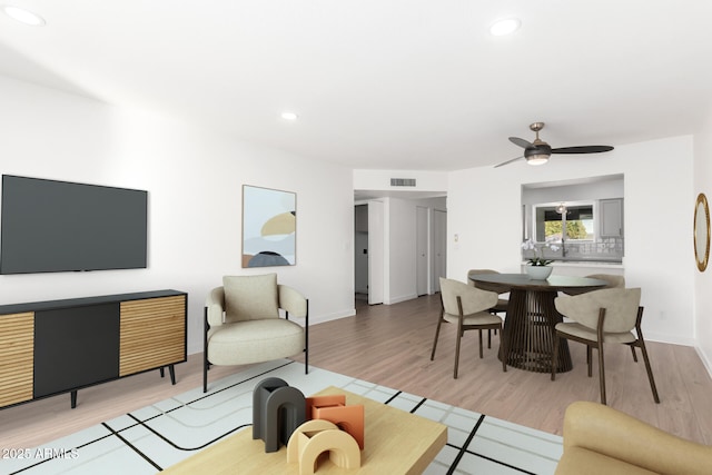 living room with ceiling fan and hardwood / wood-style floors