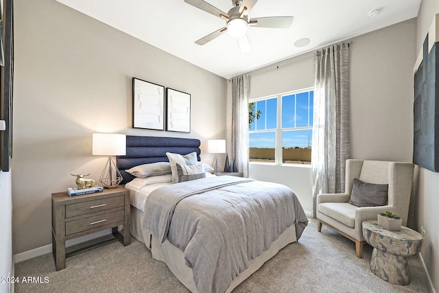 bedroom with ceiling fan and light carpet