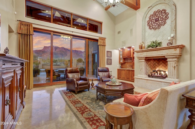 living area with beamed ceiling, high vaulted ceiling, and a high end fireplace