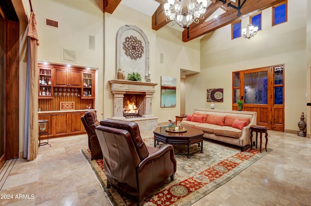 living room featuring beam ceiling, a towering ceiling, and an inviting chandelier