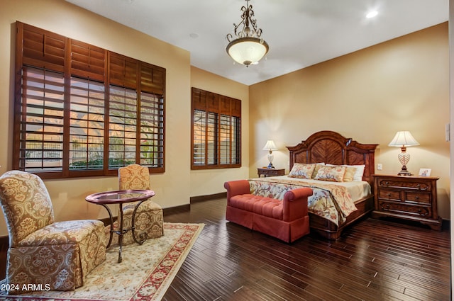 bedroom with dark wood-type flooring