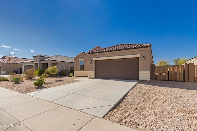 mediterranean / spanish house featuring stucco siding, concrete driveway, a tile roof, and a garage