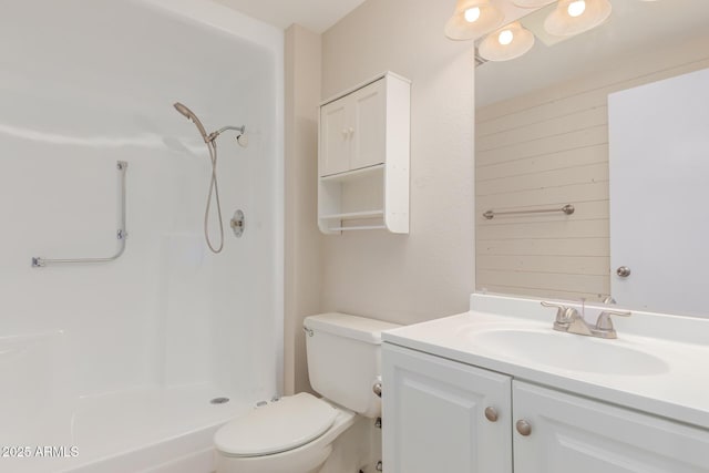 bathroom with a shower, vanity, and toilet