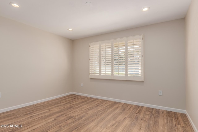 unfurnished room featuring hardwood / wood-style flooring