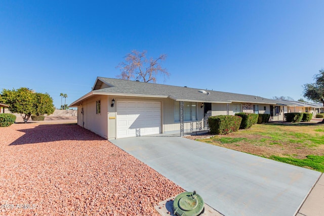 ranch-style home featuring a garage and a front lawn