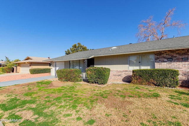 single story home featuring a garage and a front yard