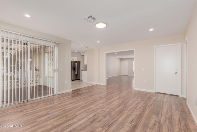 unfurnished living room featuring light wood-type flooring