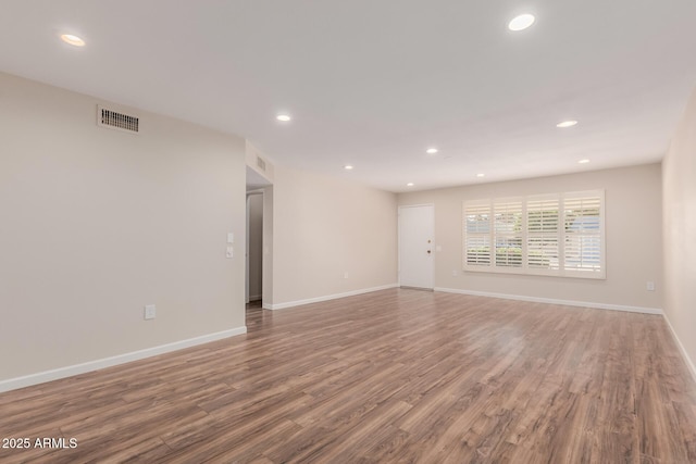 empty room with wood-type flooring