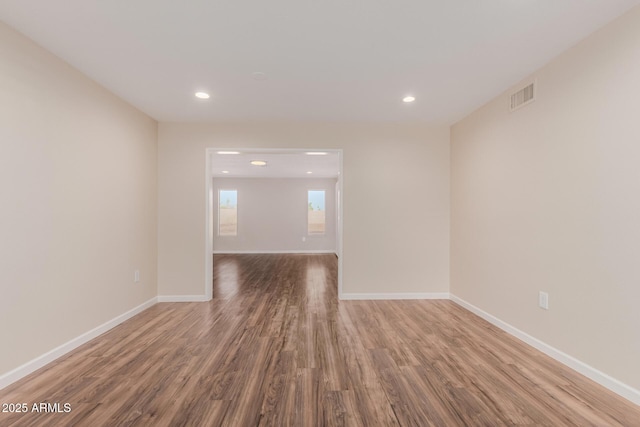 spare room with hardwood / wood-style floors