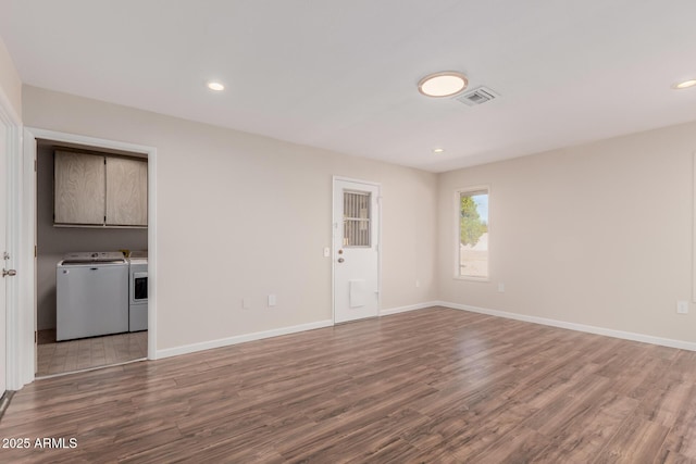 empty room featuring hardwood / wood-style flooring and independent washer and dryer