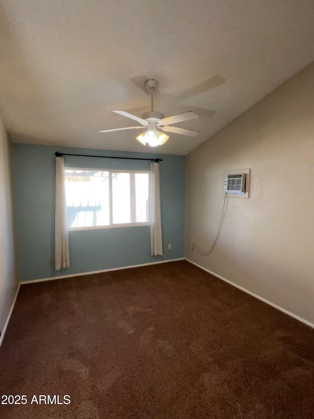 unfurnished room featuring lofted ceiling, dark colored carpet, ceiling fan, and a wall mounted air conditioner