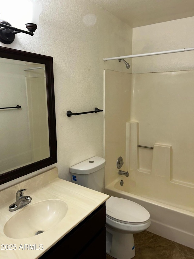 full bathroom with bathing tub / shower combination, tile patterned floors, vanity, and toilet