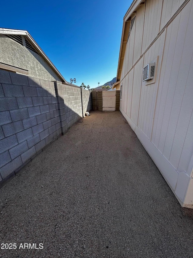 view of yard with a wall unit AC