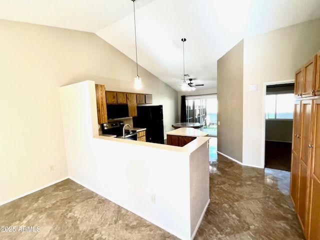 kitchen with kitchen peninsula, ceiling fan, black fridge, stainless steel range with electric cooktop, and decorative light fixtures