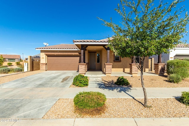 view of front facade featuring concrete driveway, stucco siding, an attached garage, and a tiled roof