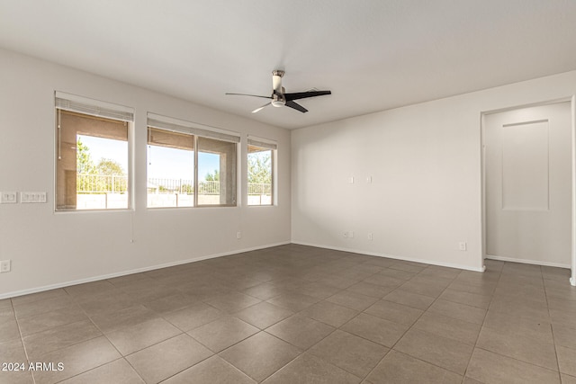 tiled spare room with plenty of natural light and ceiling fan