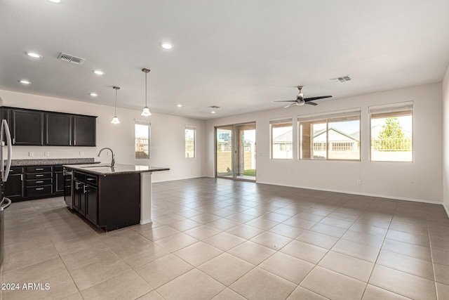 kitchen featuring visible vents, a sink, light tile patterned floors, open floor plan, and recessed lighting
