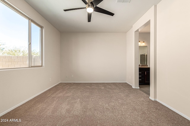 empty room with ceiling fan and carpet