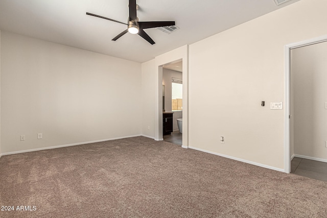 empty room with ceiling fan and carpet floors