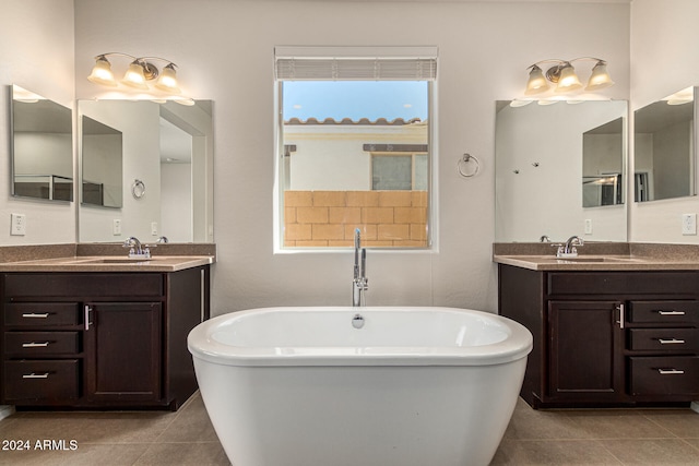 bathroom with a bathtub, tile patterned flooring, and vanity