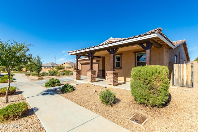 bungalow-style house with stucco siding and a tile roof