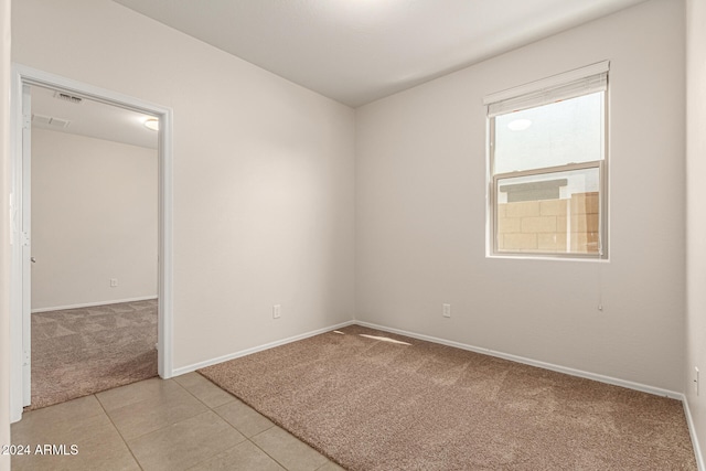 empty room featuring light colored carpet