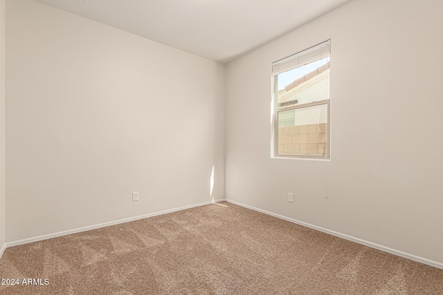 spare room with carpet floors and baseboards