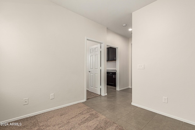 unfurnished room with tile patterned flooring