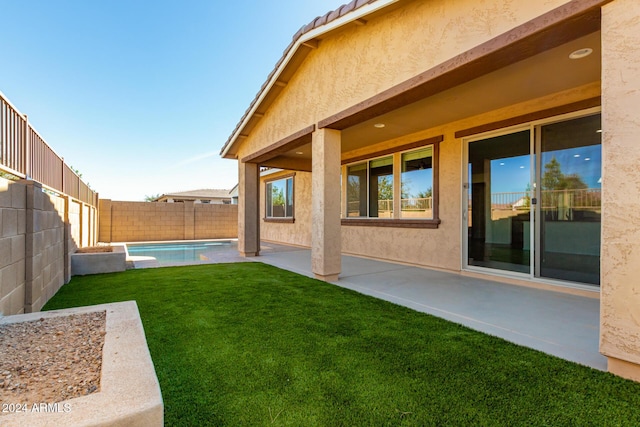 view of yard with a fenced backyard, a fenced in pool, and a patio area