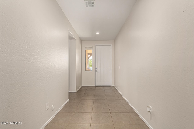 hallway featuring light tile patterned floors