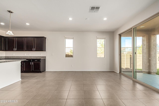 interior space with visible vents, recessed lighting, light tile patterned floors, and dark brown cabinetry