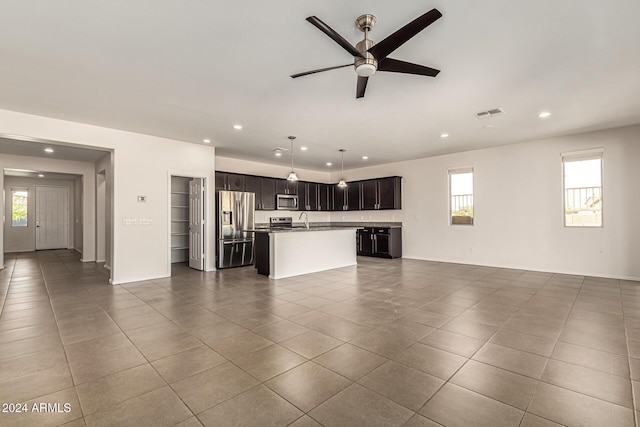 unfurnished living room featuring plenty of natural light, ceiling fan, and recessed lighting