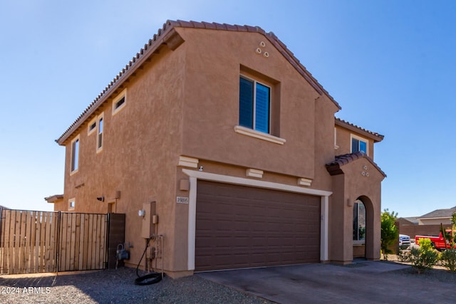 view of side of home featuring a garage