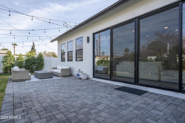 view of patio / terrace with an outdoor hangout area and fence