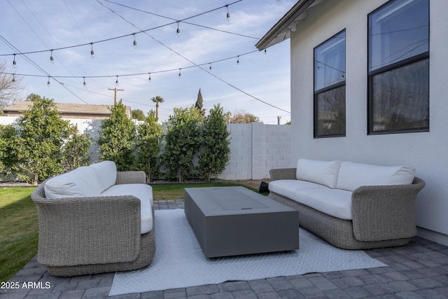 view of patio featuring fence and an outdoor hangout area